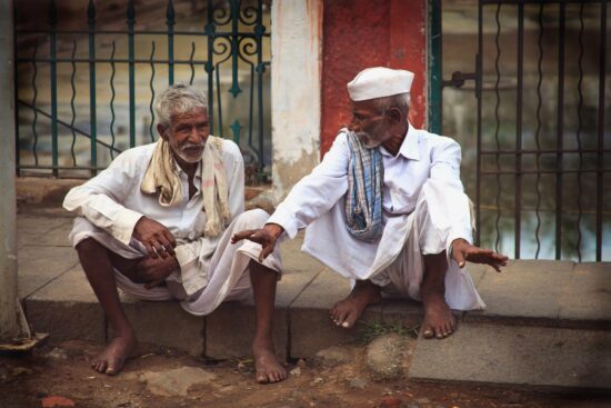 elderly men talking on the street